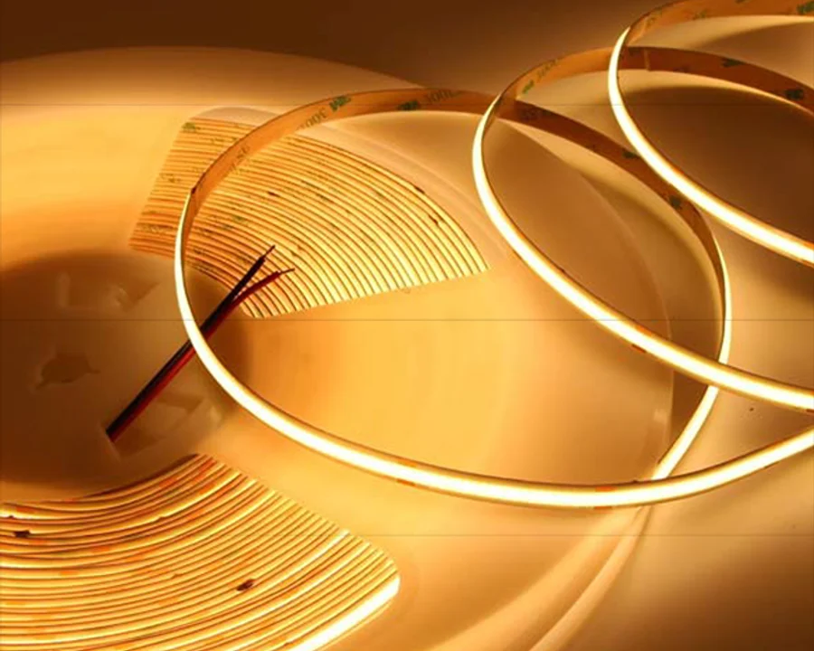 Dot-less COB LED strip light coiled and lit warm white